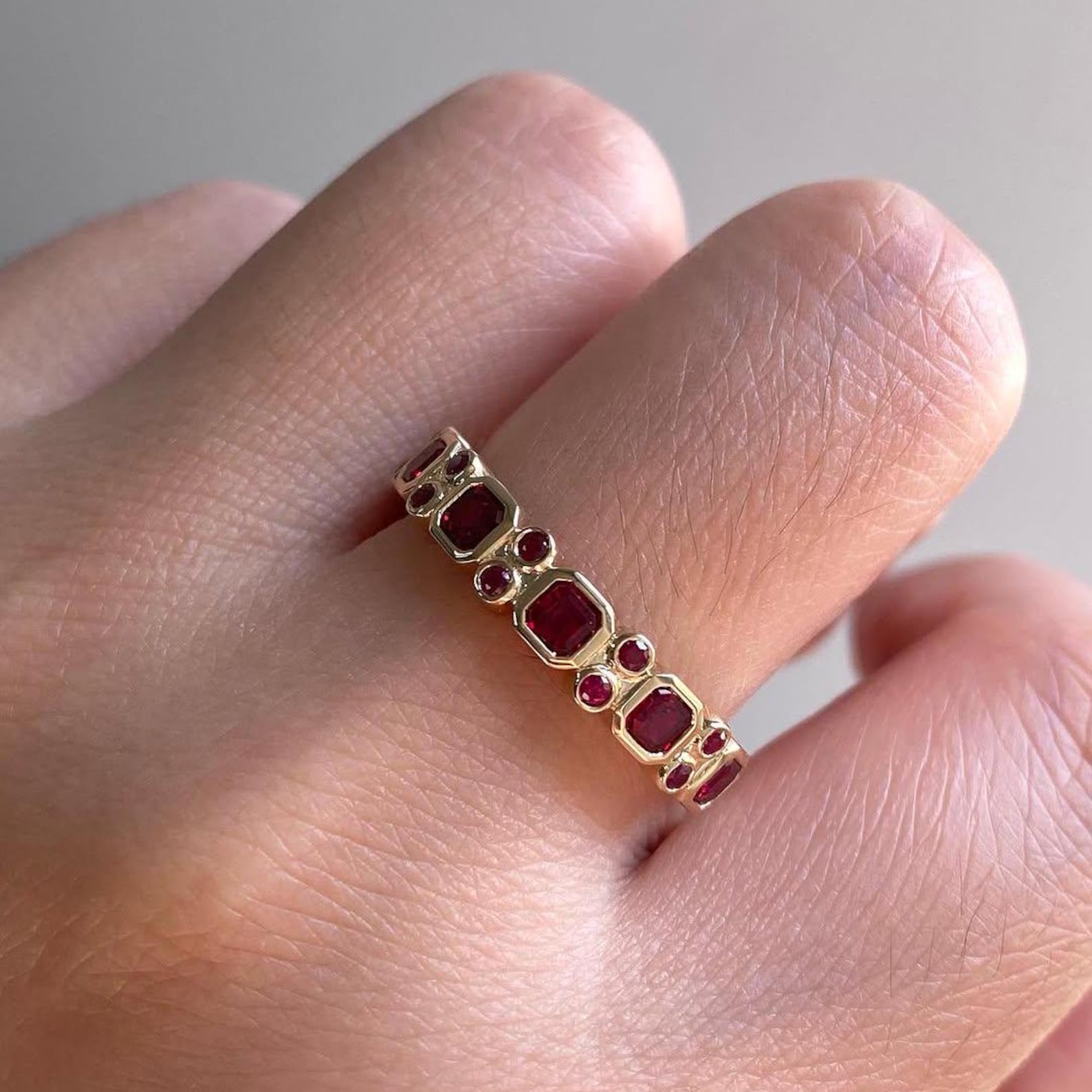 Elegant Ruby Wedding Band In Model Hand
